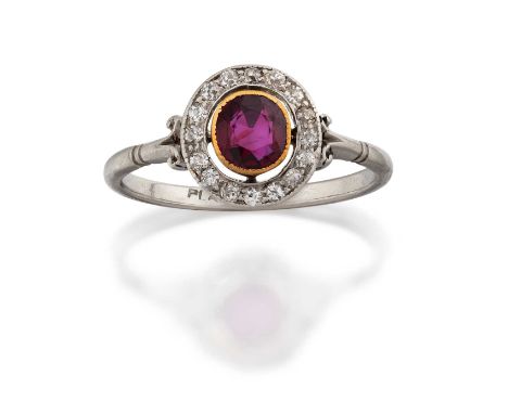 the round cut synthetic ruby in a yellow millegrain setting, to a spaced old cut diamond border, in white claw and millegrain