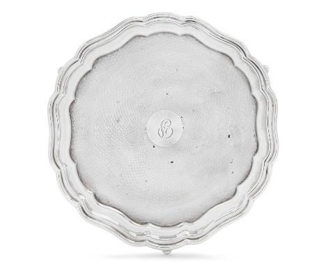 shaped circular and on three panel feet, overall engine-turned and later engraved with an initial25cm diameter, 13oz 3dwt, 40