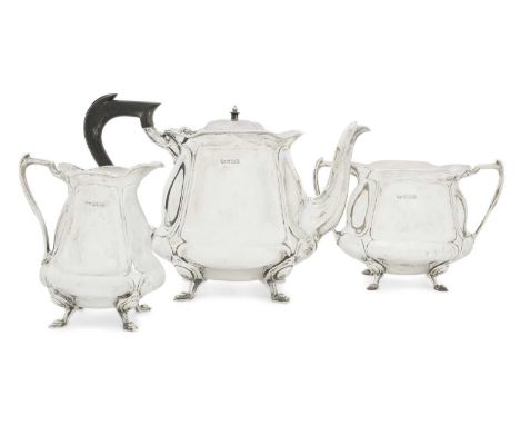 each piece in the Art Nouveau style, on four shaped panel feet, comprising: a teapot, with ebonised wood handle; a cream-jug 