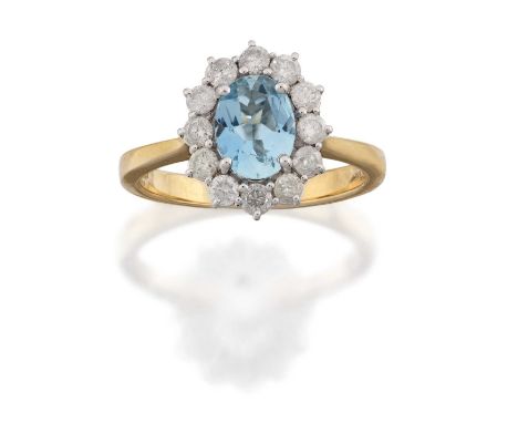 the oval cut aquamarine within a border of round brilliant cut diamonds, in white claw settings, to a yellow tapered shoulder