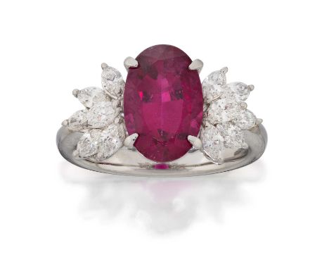 the oval cut pink tourmaline flanked by clusters of five marquise cut diamonds, in white claw settings, to a tapered shoulder