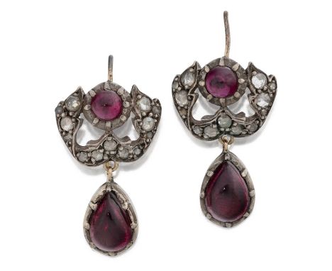 a scroll set throughout with rose cut diamonds surmounted by a round cabochon garnet, suspending a pear shaped cabochon garne