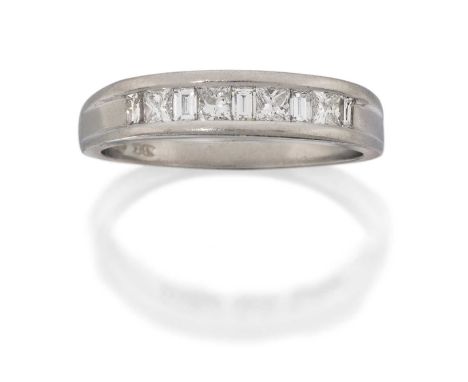 four princess cut diamonds alternate with five baguette cut diamonds, in a channel setting, to a plain polished shank, total 