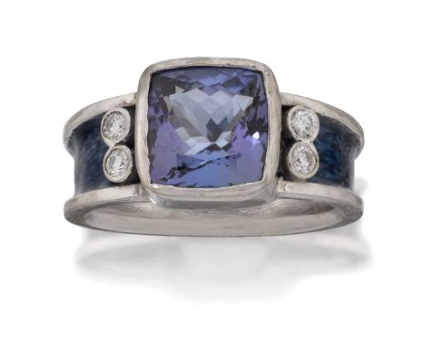 the cushion shaped tanzanite flanked by pairs of round brilliant cut diamonds, in rubbed over settings, to a channel set blue