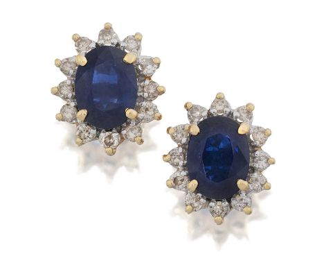 the oval cut sapphires within a border of round brilliant cut diamonds, in yellow claw settings, total estimated diamond weig