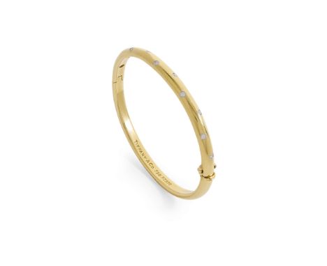  Tiffany & Co: A diamond 'Etoile' bangle  Of hinged design, the front half gypsy-set with ten small round brilliant-cut diamo