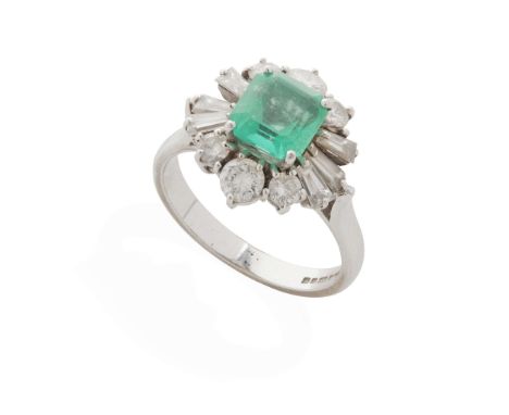  An 18ct gold emerald and diamond cocktail ring  Claw-set with a square step-cut emerald, in a border of graduated round bril