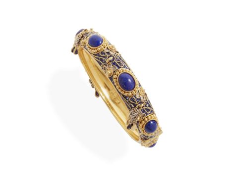  A lapis lazuli and blue enamel bangle  Of hinged design, set with seven cabochon lapis lazuli and blue enamel detail, blue e
