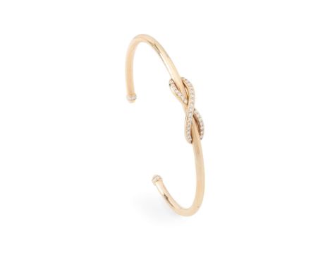 Tiffany & Co: A diamond 'Infinity' bangle  The plain bangle with round brilliant-cut diamond infinity symbol, the terminals 