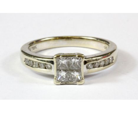 An 18ct white gold princess cut diamond set cluster ring with diamond set shoulders, approx. 0.5ct centre (N).