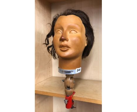 A mid 20th Century French rubber mannequin head with clamp fitting for window/shop display by J. Leclabart, H. 43cm.