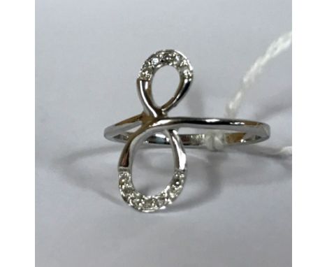 A 9ct white gold diamond set infinity ring, ring size O.