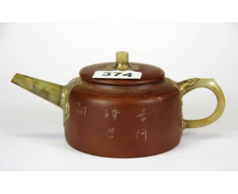 A Chinese Yixing terracotta teapot with jade spout and handle, W. 18cm.