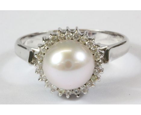 An 18ct white gold (stamped 750) pearl and diamond set cluster ring, (P).