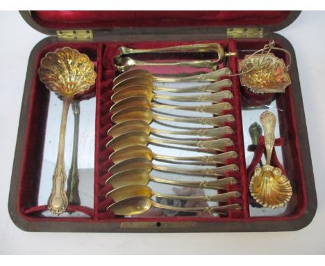 A late 19th/early 20th century French white metal dessert service set consisting of a sugar sifting spoon, sugar tongs, twelv