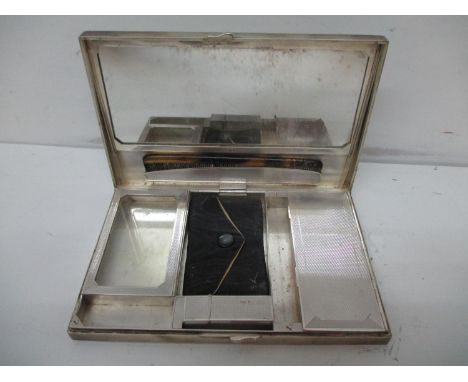 A 1930s silver combination compact/purse and cigarette box by Goldsmiths &amp; Silversmiths Ltd London 1935 of rectangular fo