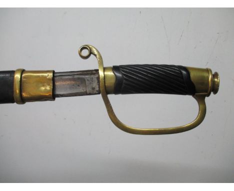 A late 19th century Zlatoust Russian sword with a carved wooden grip, brass pommel and knuckle guard and engraved blade, in a