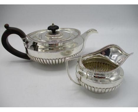 A late Victorian silver teapot, London 1894 stamp for Munday, Great Portland Street, of circular form with part fluted decora