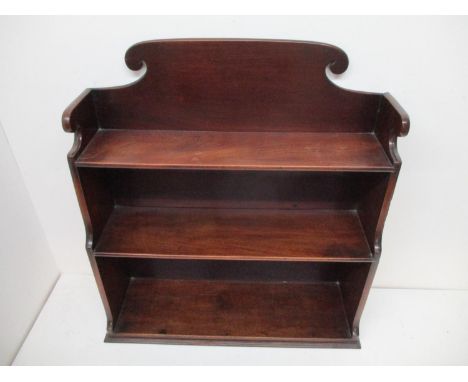 A George III mahogany three tier waterfall shelf with a shaped gallery, 26" h x 24 1/2"w x 8"d 