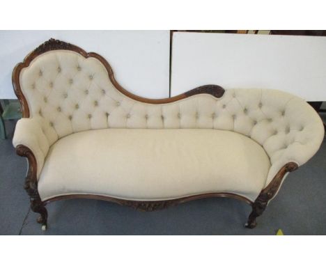 A Victorian walnut framed sofa with scrolled foliage ornament, part button upholstered in an oatmeal coloured fabric, on cabr