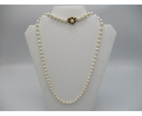 A cultured pearl necklace with an 18ct  gold pearl/diamond and ruby set clasp, 24 1/2" long, including clasp 