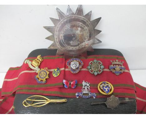 A Victorian silver breast badge and sash along with military and other badges to include British Legion, Young Helpers League