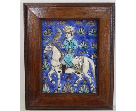 Persian glazed tile or panel decorated in a typical Qajar manner with a figure on horseback hunting with a hawk, 16.5cm x 12.