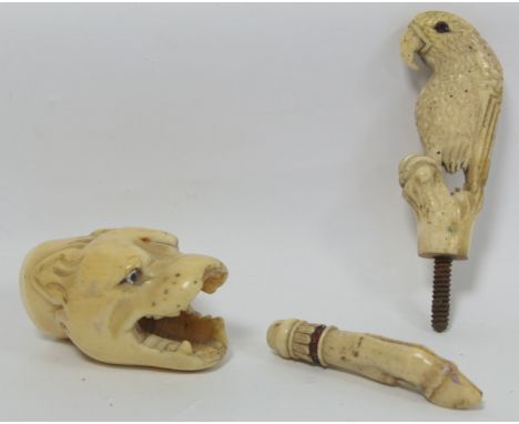 19th century ivory walking stick finial in the form of a leopard's head, 5.5cm long and two other finials in the form of a pa