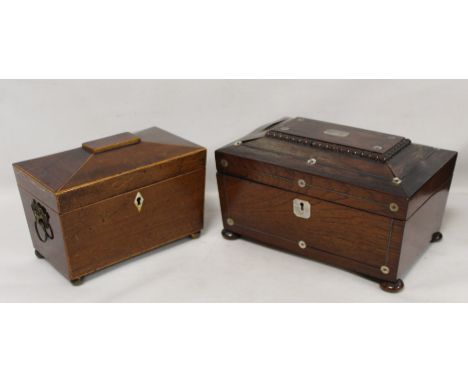 Georgian mahogany tea caddy of sarcophagus form with twin ring handles, inlaid stringing and four ball feet, the interior wit