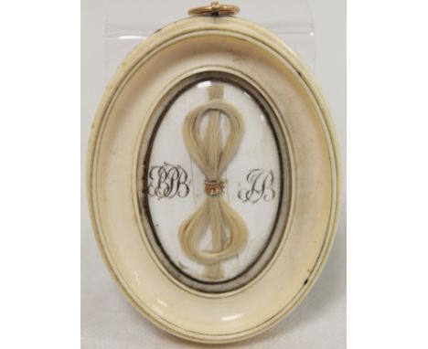 18th century small ivory oval frame containing a knot of two locks of children's hair from Barrington Pope Blachford and John