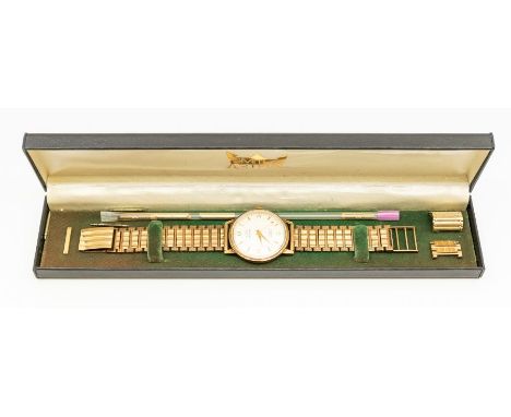 A gents 9ct gold Astral Smiths wristwatch, round champagne dial with applied gilt arrow and number markers, dial approx 29mm,