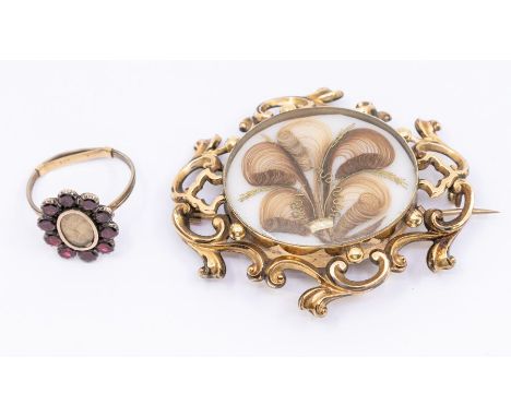 A 19th Century mourning brooch hair set, yellow metal inset to the oval centre with hair decoration within a border of scroll