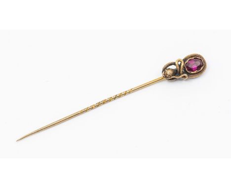 A Victorian garnet and gold serpent stick pin, set with an oval  garnet within a serpent surround, length approx 7.5cm, unmar