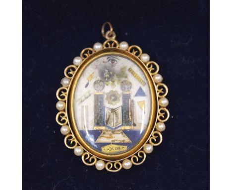 Masonic Interest: an early 19th century oval masonic pendant, depicting the all seeing eye, temple, trowel, compass, mallet a