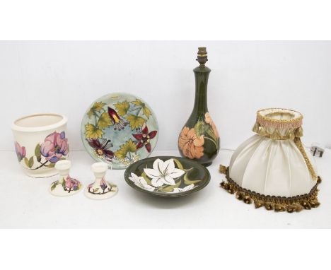 Moorcroft; a Bermuda Lily dish, a charger and a pair of cream ground Magnolia pattern candlesticks, a large Magnolia planter 