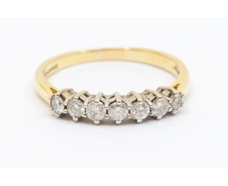 A diamond and 18ct gold eternity ring, comprising seven claw set round brilliant cut diamonds, total diamond weight approx 0.