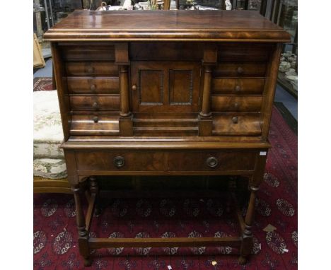 An early&nbsp; 20th Century mahogany tabernacle cabinet on stand, concealed drawer to frieze above a single door enclosing fi