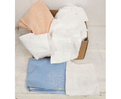 A large box of linen to include white cotton table clothes, damask cotton table clothes, appliquéd table clothes, white napki