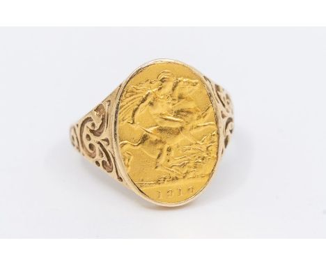 A 9ct gold ring with floral and scroll shoulders inset with a part sovereign coin, size R1/2, total gross weight approx 6.2gm