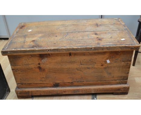 A late 19th Century pine tool trunk with cast carry handles, on block feet, 90 x 41 x 51cms approx