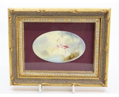 An early 20th Century&nbsp;Royal Worcester oval plaque painted with a pair of Flamingos, signed by C Johnson, puce factory ma