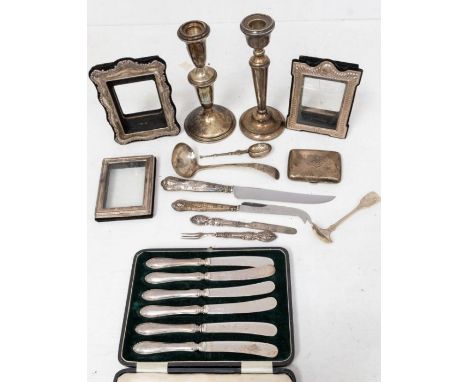 A collection of silver to include: an American Reed &amp; Barton sterling silver baluster candlestick (filled), stamped to ba