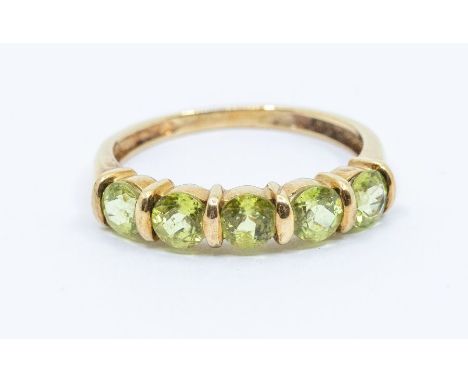 A peridot and 9ct gold ring, comprising five round cut peridot stones bar set, size O, total gross weight approx 1.9gms Furth