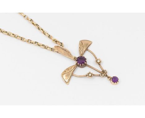 An Art Nouveau amethyst and pearl set drop 9ct gold pendant in the form of a maple seed set with a round cut amethyst with wi
