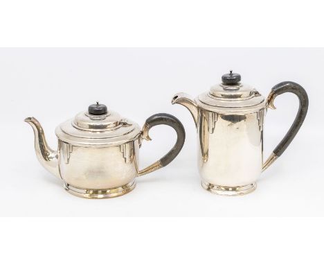 An Art Deco part silver tea service to include teapot and hot water jug, geometric chased decoration, ebonised finials and ha