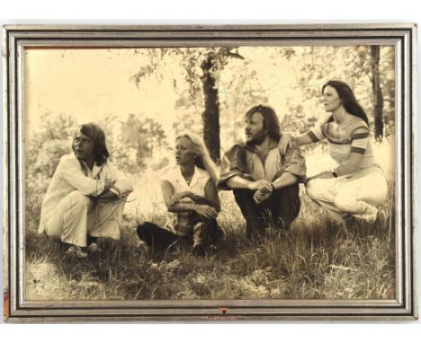 ABBA  Autographed black and white promotional still, depicted the band in a rural setting. Signed by all four members of the 
