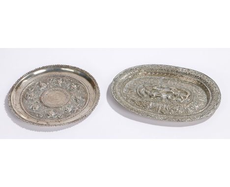 Two white metal dishes, the first with flowers surrounding a presentation inscription, 14.5cm wide, the second an oval dish w