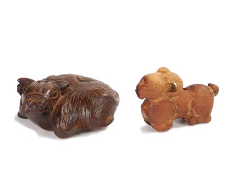 Two Japanese wood netsuke, the netsuke carved as an ox laying down and a goat, the ox 5cm diameter