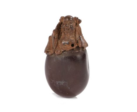 Japanese Meiji period netsuke, the netsuke a carved nut with a Chinese sage emerging from the inside, 4cm high