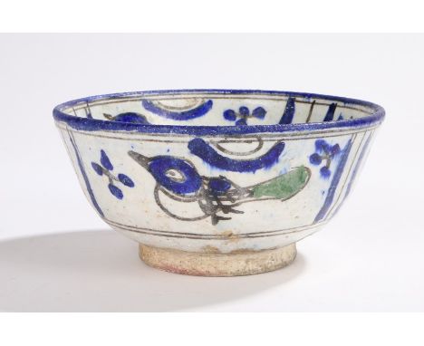 Persian design pottery bowl decorated in blue and green with a stylised portrait to the centre of the base and with birds to 
